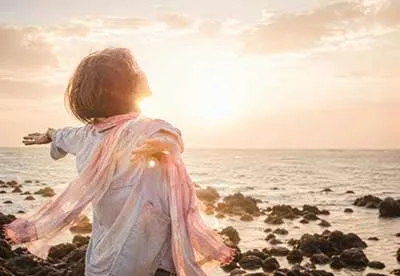 Woman embracing freedom and a new beginning after breast cancer treatment 